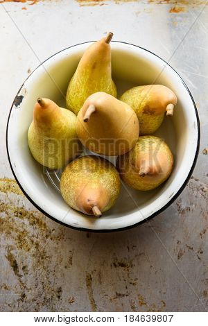 Top view of pears in bowl. Rustic vintage style still life