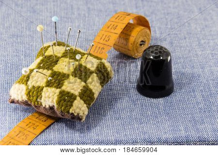Beautifully Laid Out Accessories For Needlework On A Jeans Background