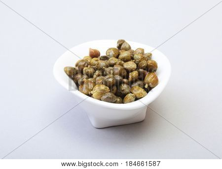 bowl with fresh capers isolated on white background
