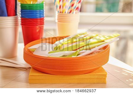 Colorful plastic ware for picnic on table