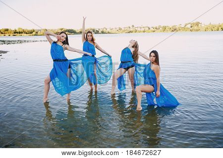 pretty girls in dresses dancing outdoors  