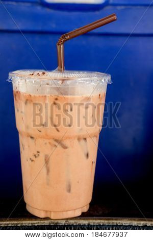 Iced mocha coffee in coffee shop with blue background