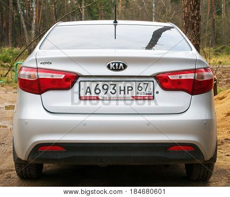 Smolensk, Russia - April 29, 2017: New Kia Rio parked in the forest, back side.