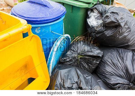 Piles of garbage in plastic bin bags (trash, waste) in City.