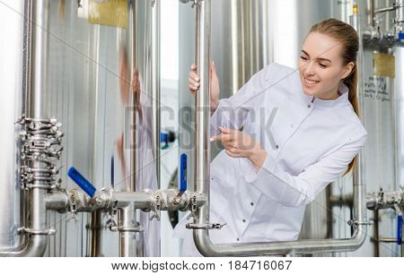 Female young attractive specialist at water factory