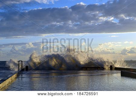 Splashing through a breakwater from a wave during a storm