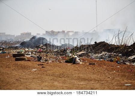 Burning garbage heap of smoke from a burning pile of garbage in senegal.