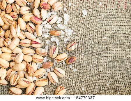 Heap Of Inshell Pistachios And Peeled Pistachios With Large Salt Crystals