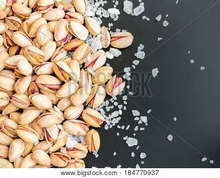 Heap Of Inshell Pistachios And Peeled Pistachios With Large Salt Crystals