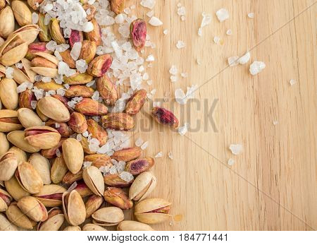 Heap Of Inshell Pistachios And Peeled Pistachios With Large Salt Crystals