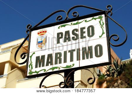 TORREMOLINOS, SPAIN - SEPTEMBER 3, 2008 - Ceramic Paseo Maritimo street sign in a wrought iron frame Torremolinos Malaga Province Andalusia Spain Western Europe, September 3, 2008.