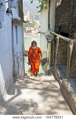 INDIA, LAXMAN JHULA - APRIL 15, 2017: Sadhu coming from the river Ganges after doing puja in Laxman Jhula on the 15th of april 2017