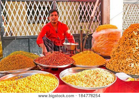 INDIA, LAXMAN JHULA - APRIL 8, 2017: Seller selling all kinds of indian food in the streets of Laxman Jhula on the 8th of april 2017