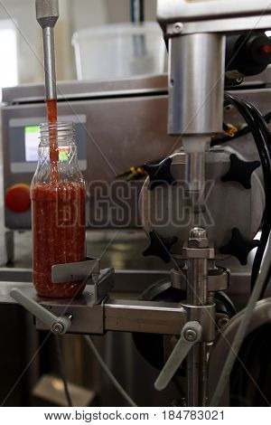 ST. PETERSBURG, RUSSIA - FEBRUARY 28, 2017: Production of ajika sauce in a food processing plant. The Factory of Homemade Pickles participates in the regional quality certification program