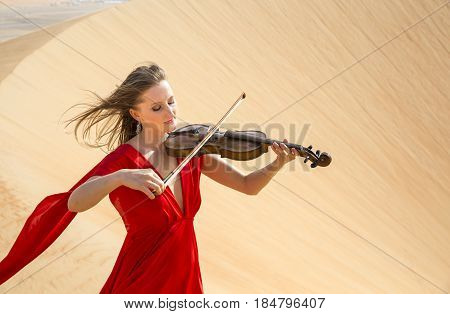 Woman In A Red Dress In A Desert In Abu Dhabi