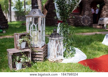 Beautiful Wedding Ceremony Outdoors. Decorated Chairs Stand On The Grass. Wedding Arch Made  Flowers