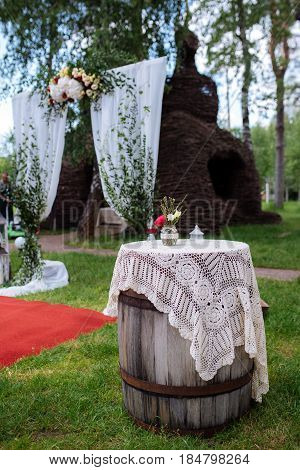 Beautiful Wedding Ceremony Outdoors. Decorated Chairs Stand On The Grass. Wedding Arch Made  Flowers