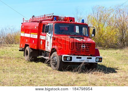Samara Russia - April 30 2017: Red fire truck EMERCOM of Russia parked up on the spring field