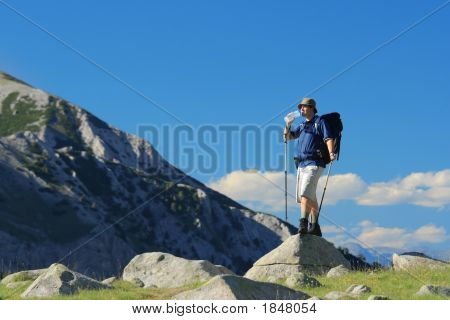 Backpacker stående på en klippe i nationalparken Pirin