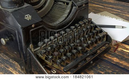 vintage keys of old typewriter macro details HDR obsolete writing machine with pen and notebook