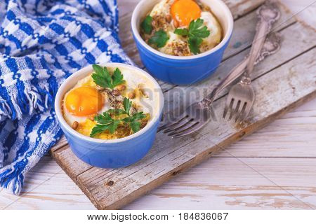 Eggs En Cocotte Baked With Spinach, Parsley And Cream.