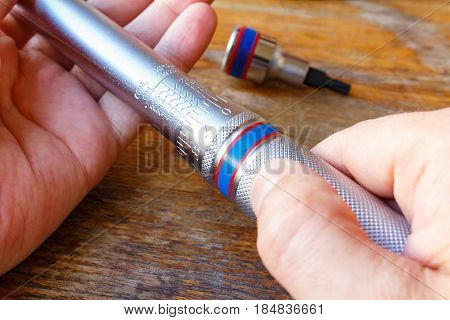 Torque wrench in the mechanic hands closeup