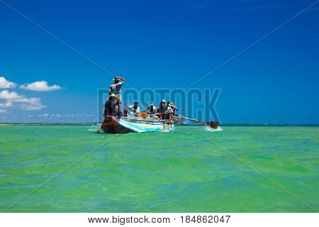 SRI LANKA - Mach 23: Local fishermen pull a fishing net from Indian Ocean on Mach 23, 2017 in Kosgoda, Sri Lanka. Fishing in Sri Lanka is the way they earn their living.