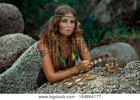 beautiful young woman with feather and tarot cards