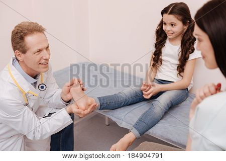 It is treatable. Joyful pleasant excellent rheumatologist telling the girl having a good chance of healing quick while giving her mom some pieces advice