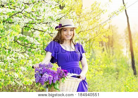 Portrait Of Young Beautiful Girl In Hat With Long Hair With Flowers In Basket On Vintage Bike. Fashi