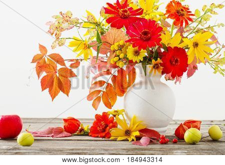 Still life with a autumn flowers and leaves