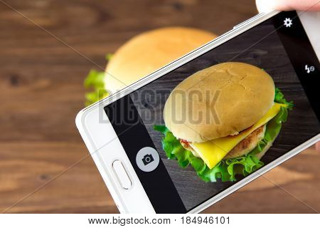 Cheesburger On The Screen Of Smartphone