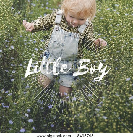 Little blonde boy walking in the meadows