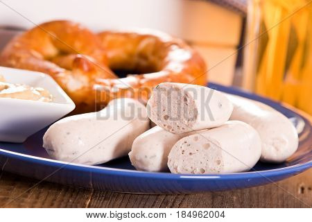 Bavarian pretzels with saisages on cutting board.