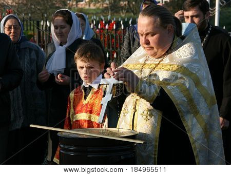 VOYUTYN UKRAINE - 14 OCTOBER 2008: Orthodox priest blessing of water during the religious celebration Pokrov