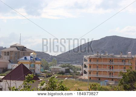 Russia. Crimea for travelers. Landscape blue sky with clouds, mountains, residential buildings