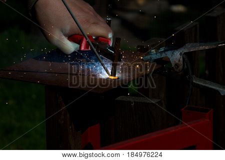 Detail of the welding of the metal material by the electrode