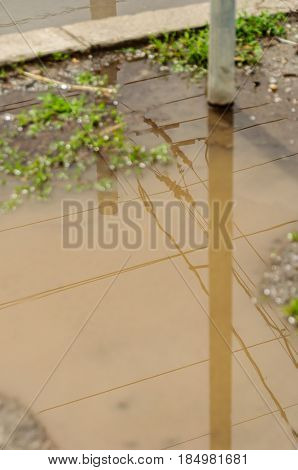 Reflection In Large Puddle On An Overcast Day
