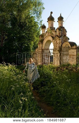The girl is walking along the old abandoned Chernyshev estate. Russia.