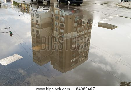 Reflection In Large Puddle On An Overcast Day