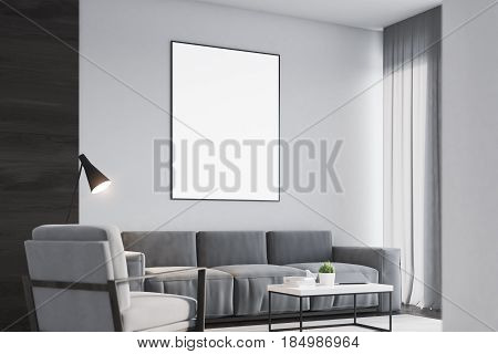Side view of a living room interior with a black wall fragment a gray armchair a sofa a coffee table and a large framed vertical poster. 3d rendering mock up