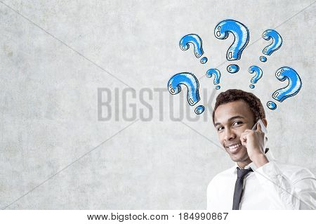 African Man With Phone And Question Marks