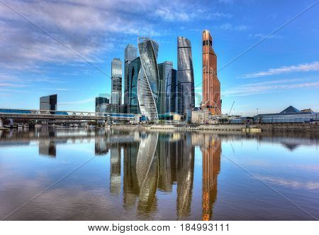 RUSSIA/ MOSCOW - MAY 1, 2017. Moscow International Business Center and pedestrian bridge Bagration on a summer morning. Moscow, Russia