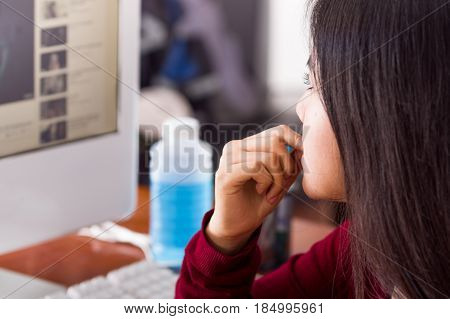 closeup of an anxious girl bitting nails.