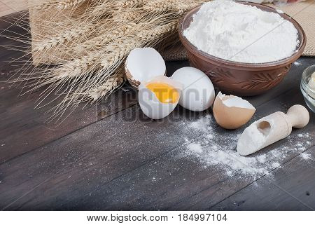 Bowl With Flour Eggs Ears Of Wheat And Butter On Vintage Wooden Board Food And Drink Concept