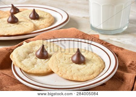 A Plae Of Homemade Sugar Cookies With Chocolate Candy And A Glass Of Milk