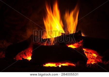Fire Burns Very Brightly In A Fireplace And Gives Heat