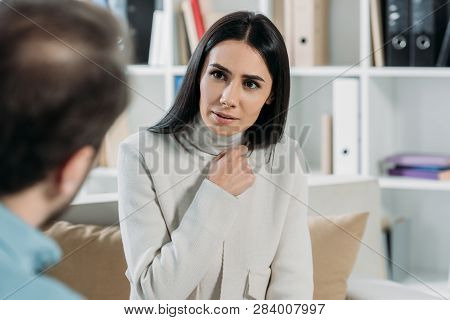 Selective Focus Of Unhappy Young Patient Looking At Psychiatrist In Office