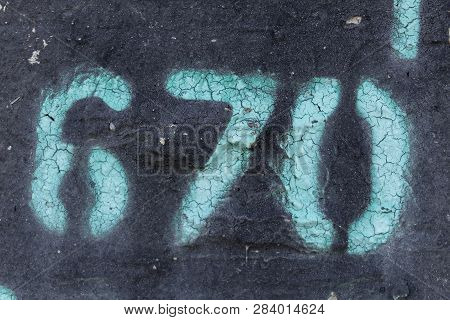 Stencil Number In Spray Paint, Number 
Six Hundred And Seventy Painted Stencil On Blak Backdrop