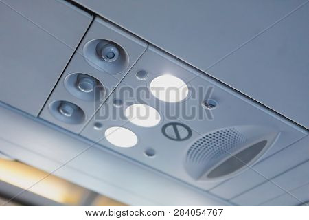 overhead light and air conditioner in airplane cabin